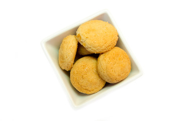 Stuffed biscuits on square bowl on a white background viewed from above
