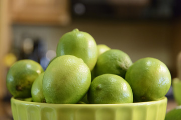 Bowl of Green Limes blur background