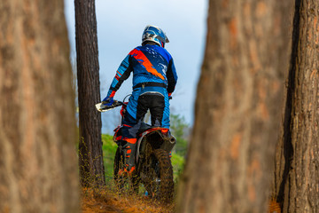 man riding a motocross in a protective suit