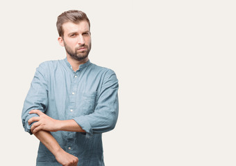 young handsome man, blue denim shirt, facing to a challenge and proud expression . person isolated...