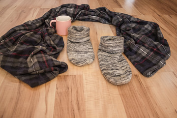 Left blanket, socks and mug.