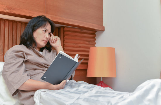 Wife thinking and read book in bedroom