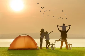 Fotobehang Gelukkig gezin kamperen in de buurt van het meer met zonsondergang of zonsopgang achtergrond, gelukkig familieconcept © ittipol