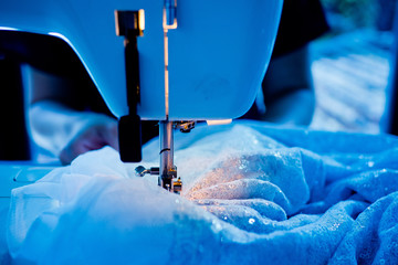 sew machine closeup hand