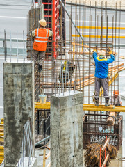 Construction workers are working on a construction site in Kiev, Ukraine. Concrete construction works and assembly of metal structures are carried out.