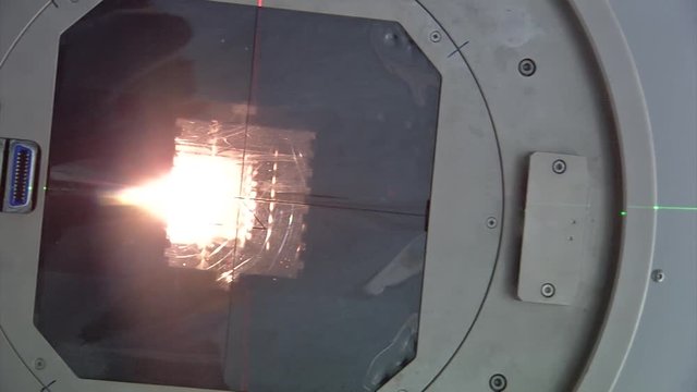 Close up view looking up into a linear accelerator cancer radiation machine as it passes overhead