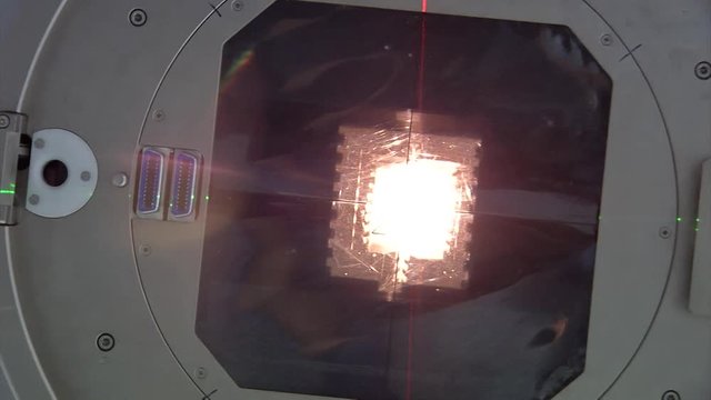 Close up view looking up into a linear accelerator cancer radiation machine as rotates in and stops overhead
