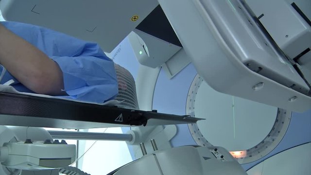 Low angle medium side view of a male patient going through radiation therapy