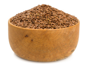 flax seeds in a wooden cup isolated on a white background