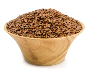 flax seeds in a wooden cup isolated on a white background