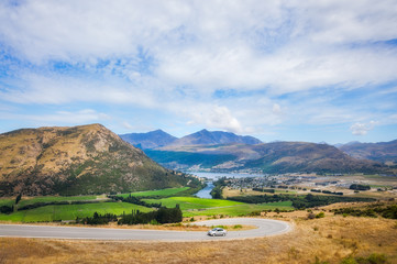 A Car driving up the winding road from Queenstown to The Remarkable Ski Area