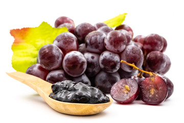 Red grapes and jam on a white background