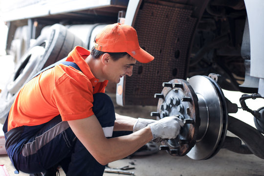 
A Mechanic Repairs A Truck. Replace Brake Disc And Pads