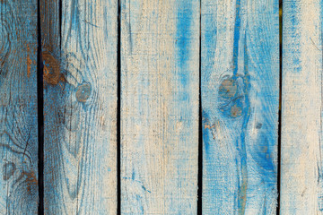 Fototapeta na wymiar Texture of an old painted blue fence made of wood