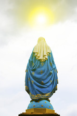 Fototapeta premium Virgin Mary statue with cloud background