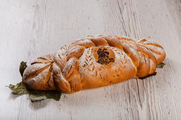 Freshly baked bread on a wooden background.