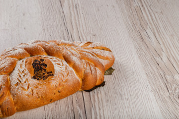 Freshly baked bread on a wooden background.