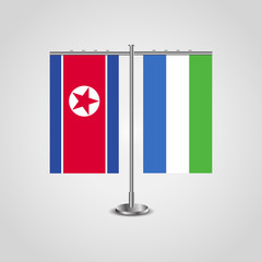 Table stand with flags of North Korea and Sierra Leone.Two flag. Flag pole. Symbolizing the cooperation between the two countries. Table flags