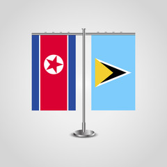 Table stand with flags of North Korea and Saint Lucia.Two flag. Flag pole. Symbolizing the cooperation between the two countries. Table flags