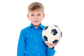 Little boy is playing with a soccer ball.