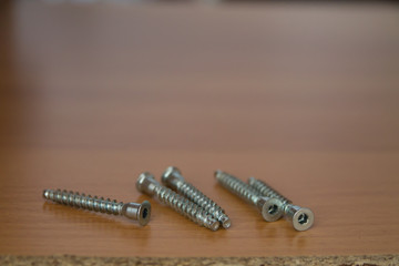 hexahedron and screws in a wooden board