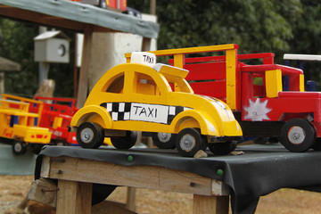 Costa Rica roadside store selling wooden toys- a yellow taxi cab
