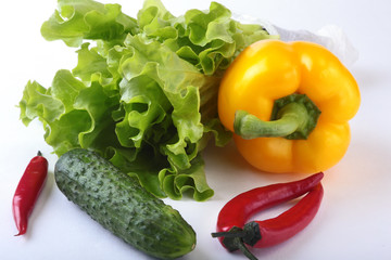 Assorted vegetables, fresh bell pepper, tomato, chilli pepper, cucumber and lettuce isolated on white background. Selective focus.