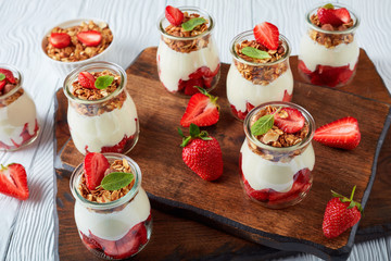 granola with yogurt in glass jars