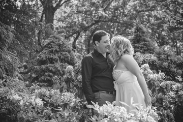 Romantic tenderness bride and groom at park. Young lady plus size enjoying moments in summer time. Beautiful bride posing with groom in her wedding day, pretty girl in a wedding dress 