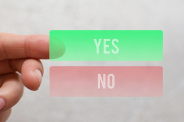 Finger pressing  green yes button on virtual touchscreen on light beige background. Decision making...