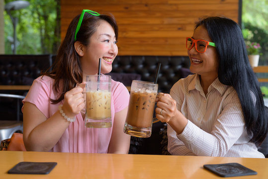 Two Mature Asian Women Together Hanging Out At The Coffee Shop