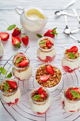 granola .yogurt, strawberries in glass jars