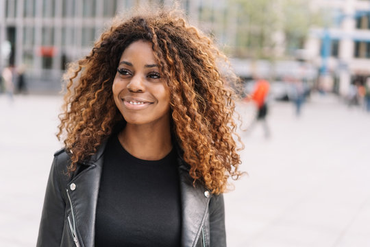 Trendy happy friendly young African woman