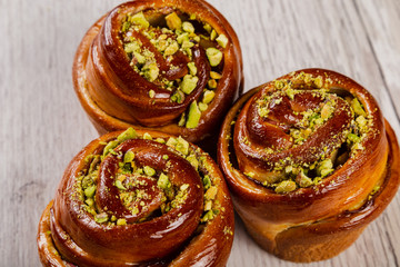 Ruddy fresh beautiful buns on a wooden background.