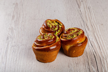 Ruddy fresh beautiful buns on a wooden background.