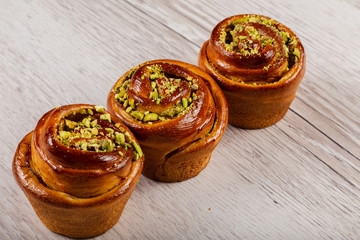 Ruddy fresh beautiful buns on a wooden background.