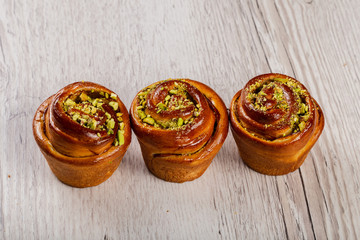 Ruddy fresh beautiful buns on a wooden background.