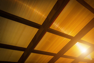 The roof of the veranda is made of orange polycarbonate.