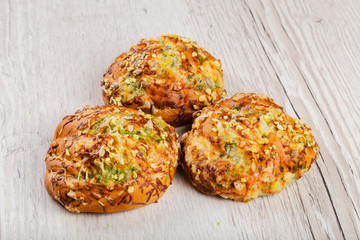 Ruddy fresh beautiful buns on a wooden background.