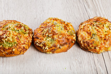 Ruddy fresh beautiful buns on a wooden background.