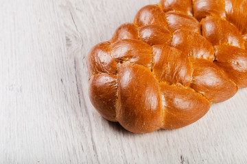 Freshly baked bread on a wooden background.