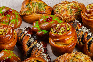 Ruddy fresh beautiful buns on a wooden background.