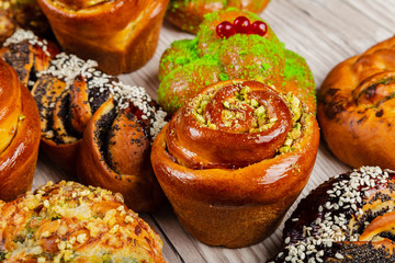 Ruddy fresh beautiful buns on a wooden background.