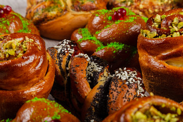 Ruddy fresh beautiful buns on a wooden background.
