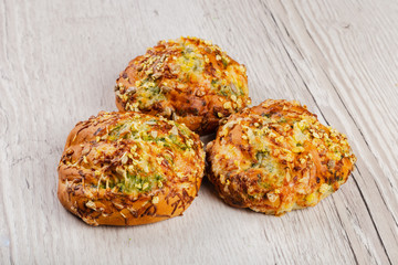 Ruddy fresh beautiful buns on a wooden background.