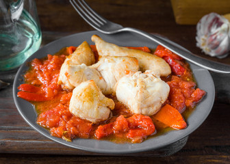 homemade fried chicken stew with peppers on wooden board
