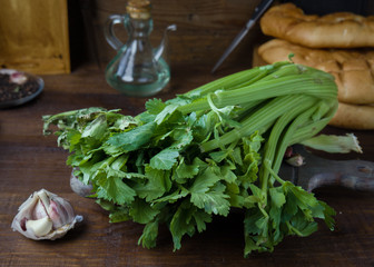 celery garlic and oil on rustic wood