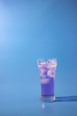 cocktail on blue background vertical right position.