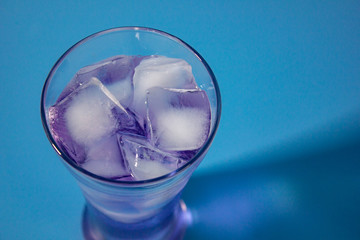 cocktail on blue background closeup top view.