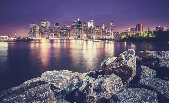 Manhattan skyline seen from Brooklyn at night, color toned picture, New York City, USA.